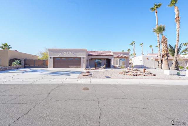 pueblo-style house featuring a garage