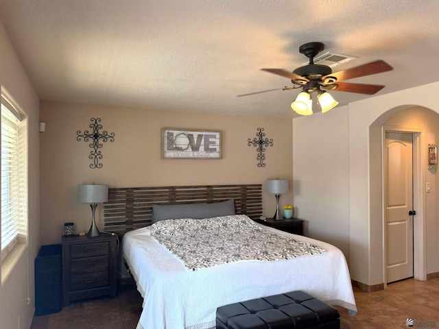 14551 E 49th St, Yuma, AZ 85367 - bedroom with visible vents, arched walkways, ceiling fan, and tile patterned floors