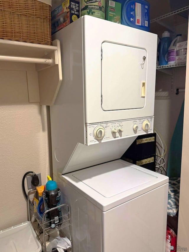 14551 E 49th St, Yuma, AZ 85367 - laundry room featuring stacked washer and dryer and laundry area