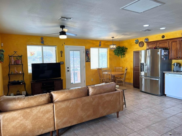 14551 E 49th St, Yuma, AZ 85367 - living room featuring a ceiling fan, visible vents, and a healthy amount of sunlight