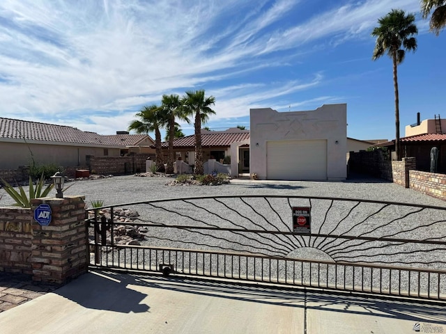 14551 E 49th St, Yuma, AZ 85367 - view of front facade with a garage, a gate, stucco siding, and driveway