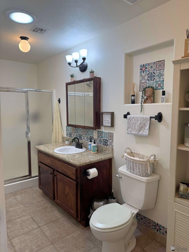 14551 E 49th St, Yuma, AZ 85367 - full bathroom featuring vanity, visible vents, toilet, tile patterned floors, and a stall shower