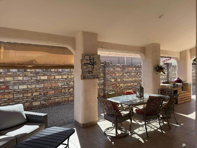 14551 E 49th St, Yuma, AZ 85367 - tiled dining room featuring brick wall