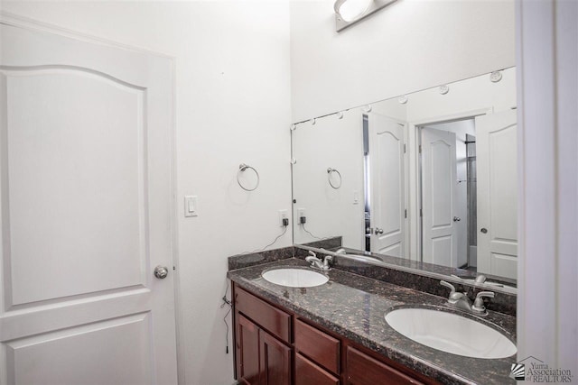 full bath featuring double vanity and a sink