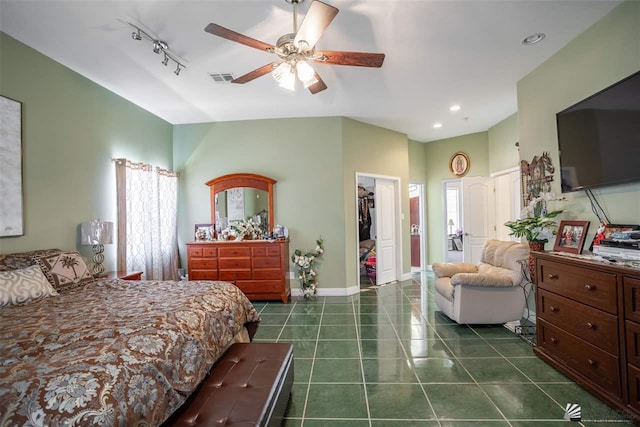bedroom featuring visible vents, track lighting, baseboards, dark tile patterned floors, and a ceiling fan