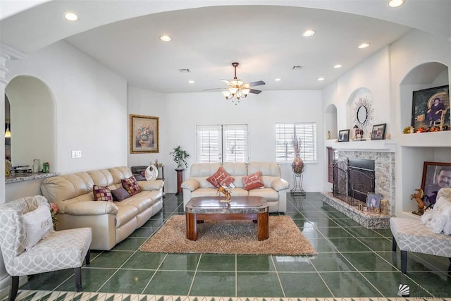 living room with ceiling fan, a stone fireplace, visible vents, tile patterned floors, and recessed lighting