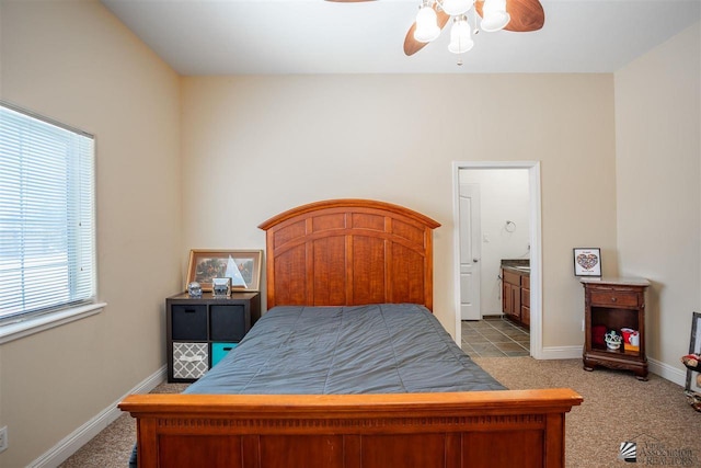 carpeted bedroom featuring baseboards, a ceiling fan, and connected bathroom