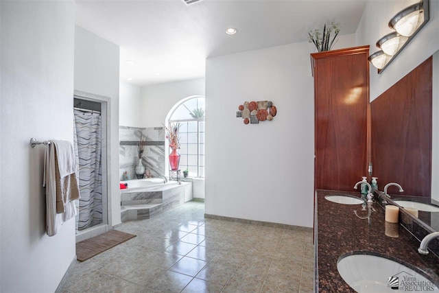 full bathroom featuring baseboards, a sink, and tile patterned floors