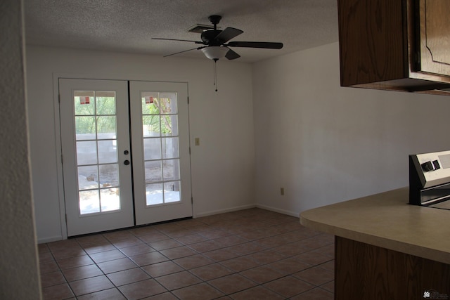 doorway featuring french doors, light tile patterned floors, plenty of natural light, and ceiling fan