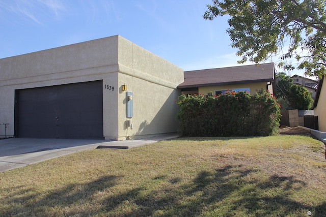 view of front of house with a front yard and a garage