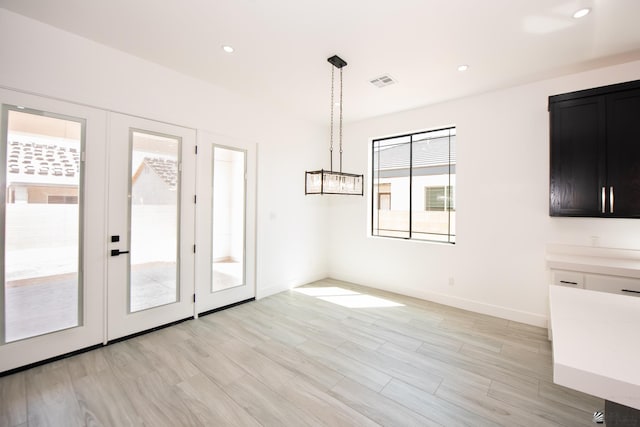 10660 E 45th Pl, Yuma, AZ 86367 - unfurnished dining area with visible vents, light wood-style flooring, baseboards, and french doors