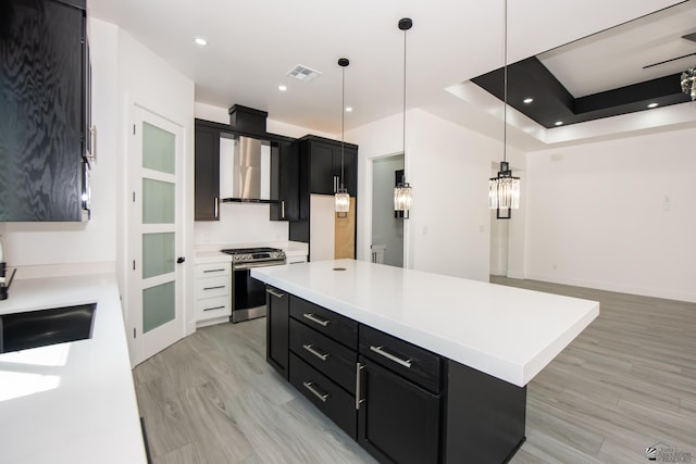10660 E 45th Pl, Yuma, AZ 86367 - kitchen with stainless steel range with gas cooktop, light countertops, dark cabinets, and light wood-type flooring