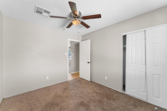 2213 W Pueblo St, Yuma, AZ 85364 - unfurnished bedroom featuring carpet flooring, a closet, a textured ceiling, ceiling fan, and baseboards