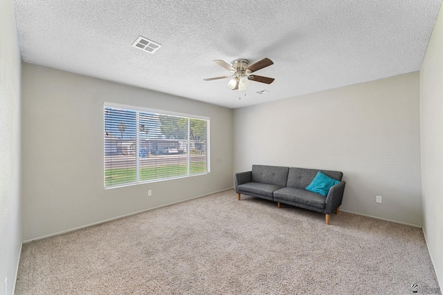 2213 W Pueblo St, Yuma, AZ 85364 - living area with a ceiling fan, carpet, a textured ceiling, and baseboards