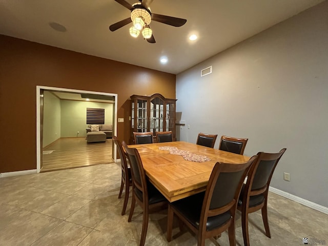 tiled dining room featuring ceiling fan