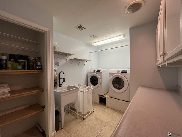 washroom with light tile patterned floors and washing machine and dryer