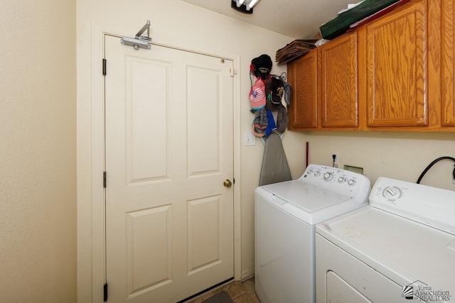 washroom featuring washing machine and clothes dryer and cabinet space