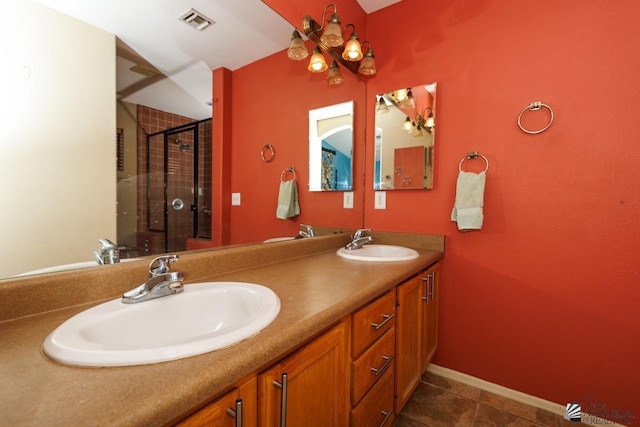 bathroom with double vanity, visible vents, a shower stall, and a sink