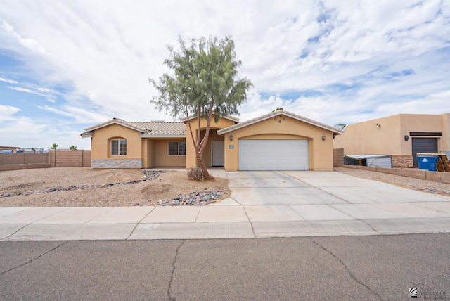 11626 E 28th Pl, Yuma, AZ 85367 - view of front of home featuring stucco siding, a tiled roof, a garage, driveway, and stone siding