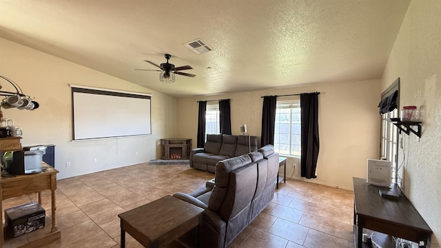 6311 E 42nd St, Yuma, AZ 85365 - home theater featuring tile patterned floors, vaulted ceiling, a ceiling fan, and a textured ceiling