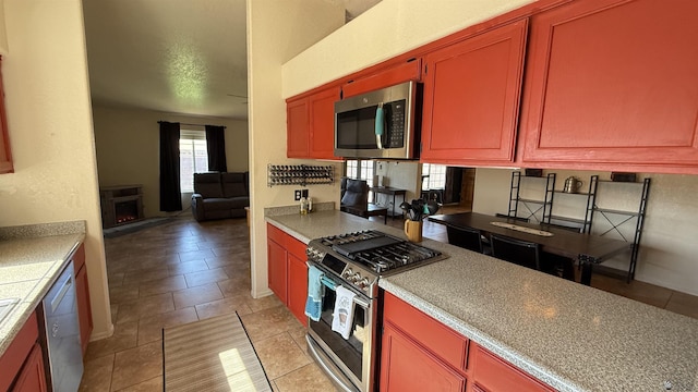 6311 E 42nd St, Yuma, AZ 85365 - kitchen with appliances with stainless steel finishes, light tile patterned flooring, light countertops, and open floor plan