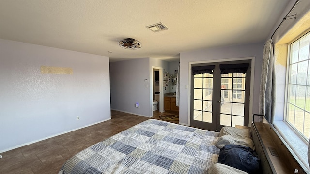 6311 E 42nd St, Yuma, AZ 85365 - bedroom featuring french doors and a textured ceiling