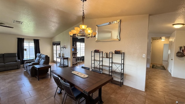6311 E 42nd St, Yuma, AZ 85365 - tiled dining area with a chandelier, vaulted ceiling, plenty of natural light, and a textured ceiling