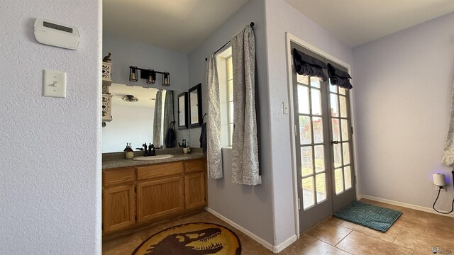 6311 E 42nd St, Yuma, AZ 85365 - bathroom with healthy amount of natural light, vanity, and tile patterned flooring