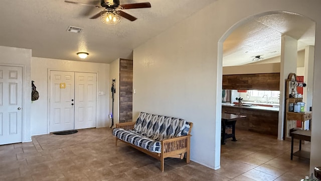 6311 E 42nd St, Yuma, AZ 85365 - foyer with a textured ceiling, arched walkways, ceiling fan, and lofted ceiling