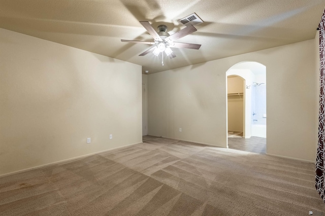 7959 E 43rd Pl, Yuma, AZ 85365 - unfurnished room featuring arched walkways, ceiling fan, light colored carpet, and visible vents