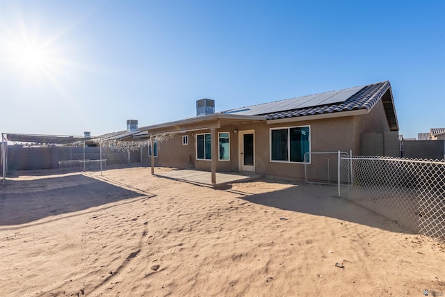 7959 E 43rd Pl, Yuma, AZ 85365 - rear view of house with stucco siding, a fenced backyard, solar panels, a patio, and a tiled roof