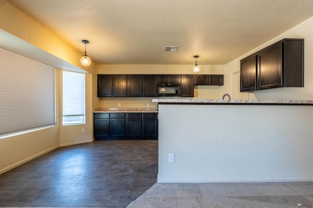 7959 E 43rd Pl, Yuma, AZ 85365 - kitchen with visible vents, dark brown cabinetry, black microwave, baseboards, and hanging light fixtures
