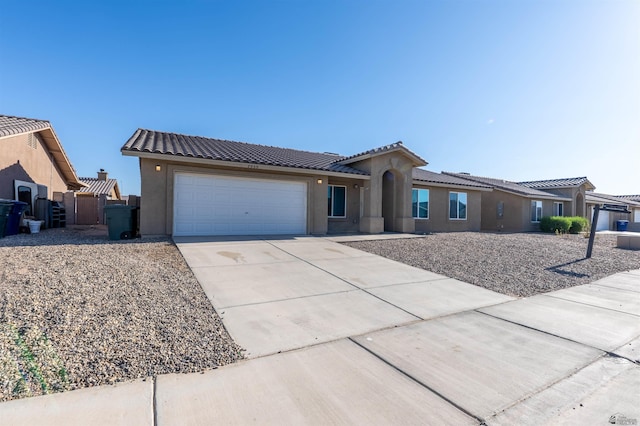 7959 E 43rd Pl, Yuma, AZ 85365 - view of front of property featuring an attached garage, stucco siding, driveway, and a tiled roof