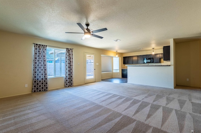 7959 E 43rd Pl, Yuma, AZ 85365 - unfurnished living room featuring ceiling fan, light colored carpet, a textured ceiling, baseboards, and visible vents