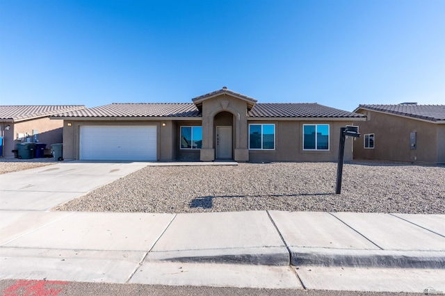 7959 E 43rd Pl, Yuma, AZ 85365 - view of front of property featuring a garage, stucco siding, a tiled roof, and concrete driveway