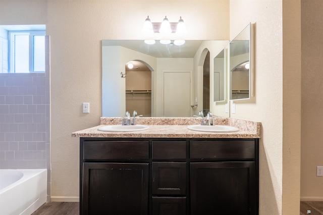 7959 E 43rd Pl, Yuma, AZ 85365 - full bathroom featuring double vanity, a sink, a textured wall, and wood finished floors