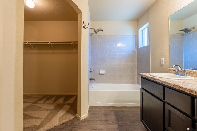 7959 E 43rd Pl, Yuma, AZ 85365 - bathroom featuring shower / bathtub combination, a spacious closet, wood finished floors, and vanity