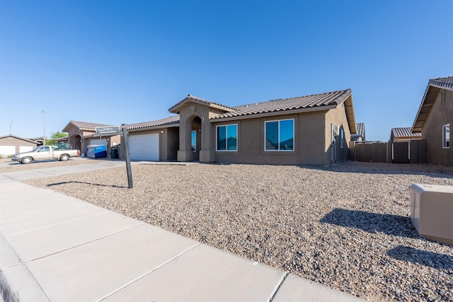 7959 E 43rd Pl, Yuma, AZ 85365 - view of front facade with stucco siding, a tiled roof, concrete driveway, and a garage