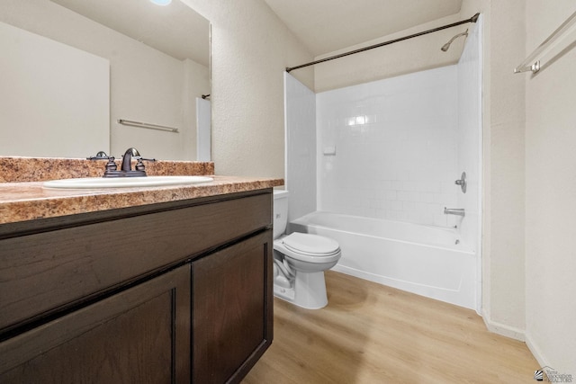 full bath featuring vanity, shower / bathtub combination, wood finished floors, and toilet