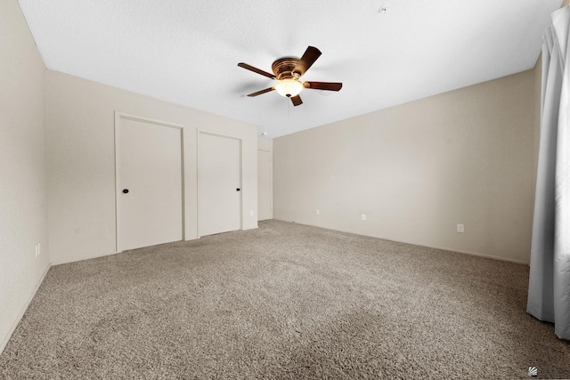 unfurnished bedroom featuring carpet flooring and a ceiling fan