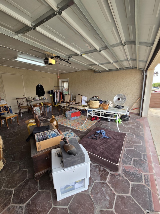 garage featuring a textured wall and a garage door opener