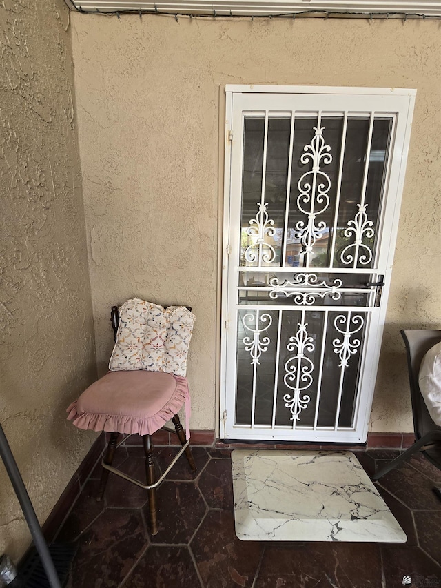 view of exterior entry featuring stucco siding