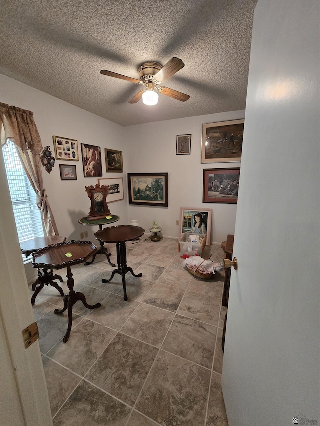 office space with a textured ceiling and a ceiling fan