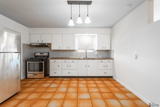 541 E Hacienda Dr, Yuma, AZ 85365 - kitchen featuring appliances with stainless steel finishes, a sink, under cabinet range hood, decorative backsplash, and white cabinetry