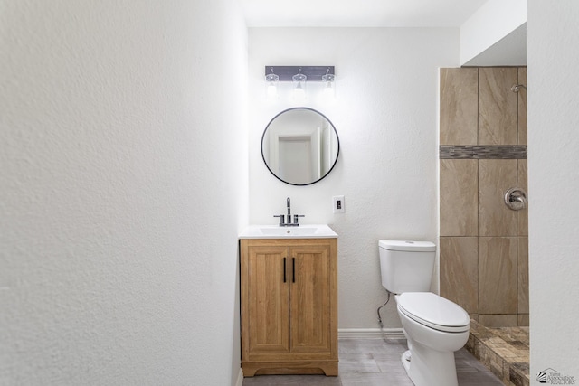 541 E Hacienda Dr, Yuma, AZ 85365 - bathroom with toilet, vanity, a tile shower, and baseboards