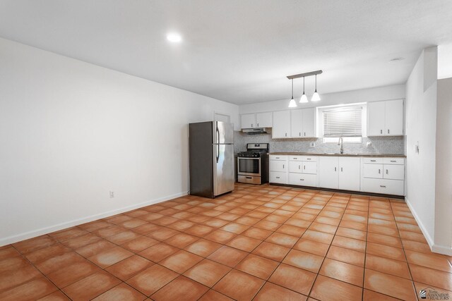 541 E Hacienda Dr, Yuma, AZ 85365 - kitchen with stainless steel appliances, a sink, white cabinetry, backsplash, and decorative light fixtures