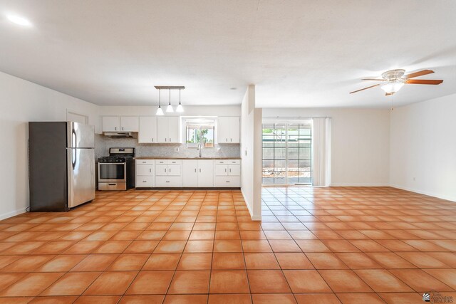 541 E Hacienda Dr, Yuma, AZ 85365 - kitchen featuring appliances with stainless steel finishes, a sink, white cabinets, ceiling fan, and tasteful backsplash