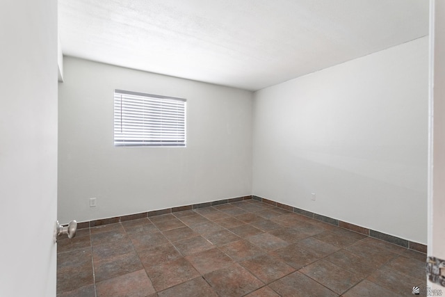 541 E Hacienda Dr, Yuma, AZ 85365 - unfurnished room with baseboards and dark stone finish flooring