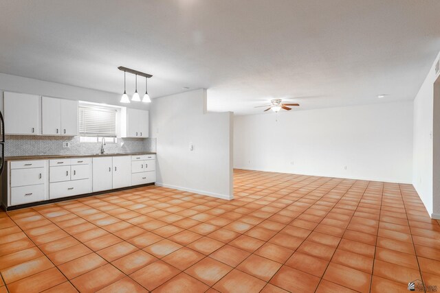 541 E Hacienda Dr, Yuma, AZ 85365 - kitchen featuring tasteful backsplash, white cabinets, a ceiling fan, baseboards, and pendant lighting