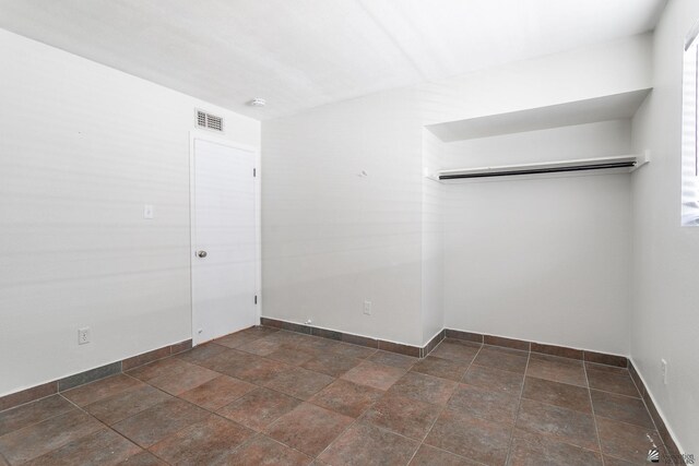 541 E Hacienda Dr, Yuma, AZ 85365 - unfurnished room featuring dark stone finish floors and baseboards